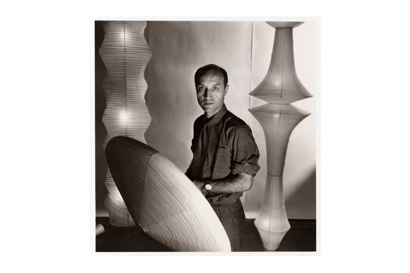 Isamu Noguchi portrait with Akari light sculptures