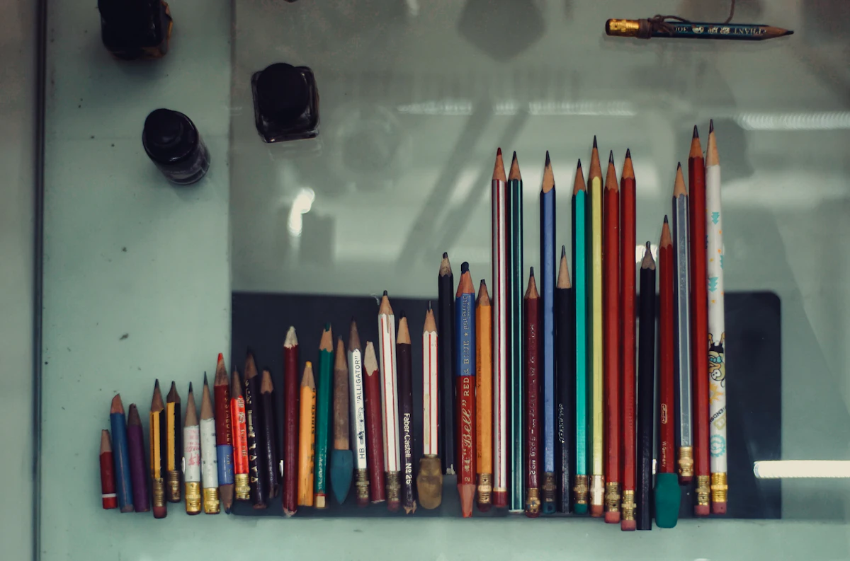 ดินสอสีหลายแท่งวางเรียงเป็นแถวบนพื้นผิว จัดวางแบบดัชนีภาพ